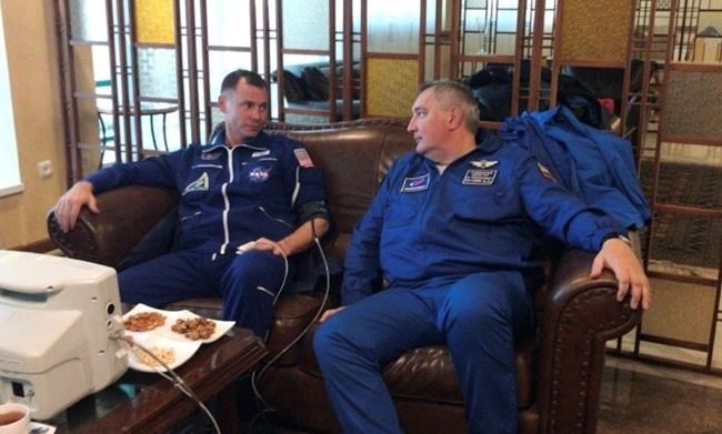 In this photo provided by Roscosmos, NASA Astronaut Nick Hague, left, and Roscosmos cosmonaut Alexey Ovchinin sit in Dzhezkazgan, Kazakhstan on Thursday, Oct. 11, 2018, after an emergency landing following the failure of a Russian booster rocket carrying them to the International Space Station.