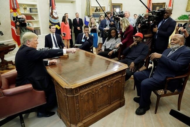 President Donald Trump talks to NFL Hall of Fame football player Jim Brown, seated right, and Rapper Kanye West, seated center, and others in the Oval Office of the White House, Thursday, Oct. 11, 2018, in Washington.