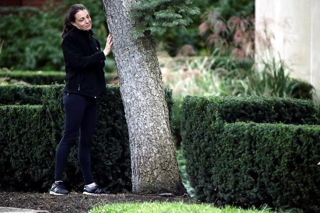 A woman touches a tree as she pauses near a memorial in front at the Tree of Life Synagogue in Pittsburgh, Monday, Oct. 29, 2018. Tree of Life shooting suspect Robert Gregory Bowers is expected to appear in federal court Monday. Authorities say he expressed hatred toward Jews during the rampage Saturday and in later comments to police.