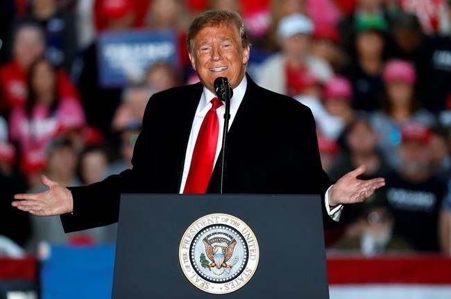 In this Oct. 27, 2018, photo, President Donald Trump speaks during a rally at Southern Illinois Airport in Murphysboro, Ill. Eager to focus voters on immigration in the lead-up to the midterm elections, Trump on Oct. 29 escalated his threats against a migrant caravan trudging slowly toward the U.S. border as the Pentagon prepared to deploy thousands of U.S. troops to support the border patrol.