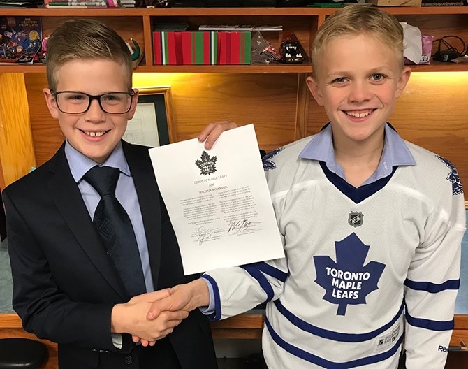 Toronto Maple Leaf fans Rhys, left, and Ryder Johnson hope there will be smiling faces and a contract in real life soon.