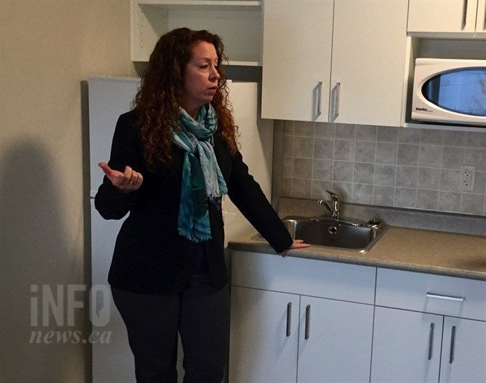 Gaelene Askeland, executive director of John Howard Society, shows the kitchen area of new Hearthstone housing unit in Kelowna, Wednesday, Oct. 31, 2018.