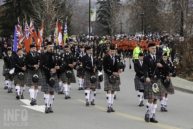 The parade down Victoria Avenue was lead by Kamloops Pipe Band Society. The procession drew a few spectators who stopped to take photos or video on their cellphones. Many wore the red poppy. 