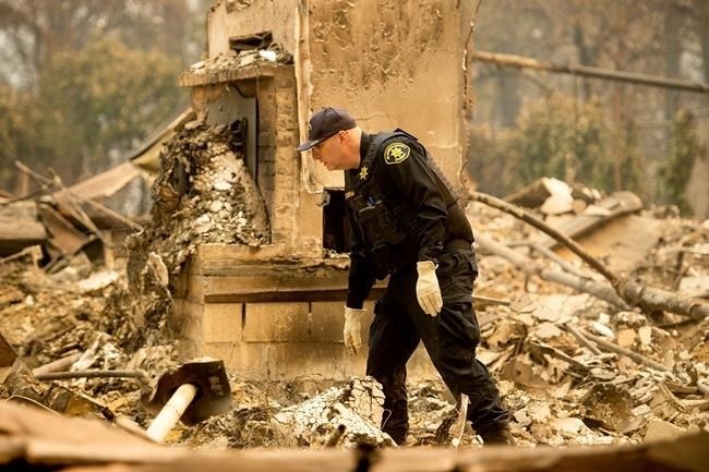 Alameda County Sheriff's deputy A. Gogna searches for victims of the Camp Fire on Monday, Nov. 12, 2018.