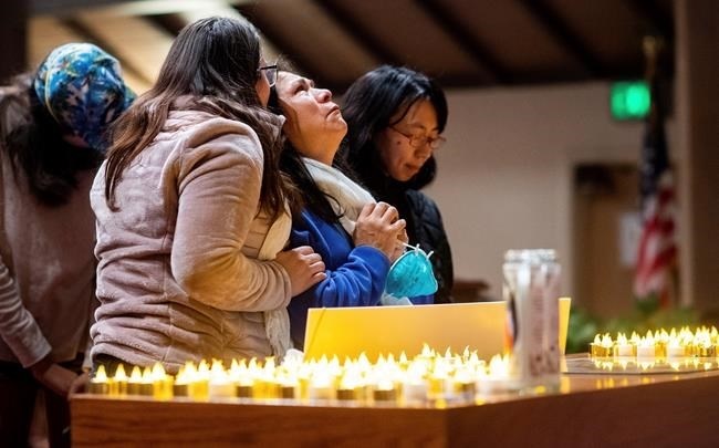 Lidia Steineman, who lost her home in the Camp Fire, prays during a vigil for fire victims on Sunday, Nov. 18, 2018, in Chico, Calif. More than 50 people gathered at the memorial for the victims. People hugged and shed tears as Pastor Jesse Kearns recited a prayer for first responders.