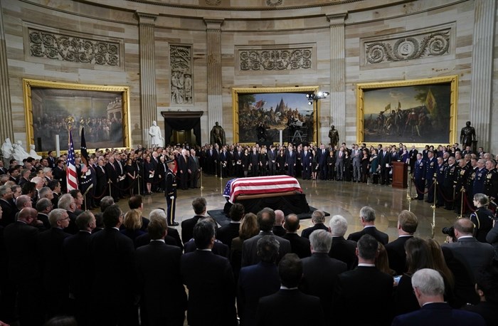 The flag-draped casket of former President George H.W. Bush lies in state in the Capitol Rotunda in Washington, Monday, Dec. 3, 2018.