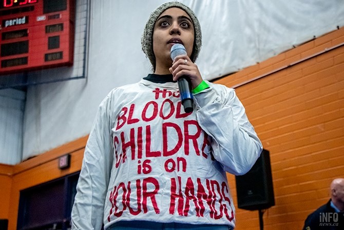 A woman wearing a T-shirt with the words 