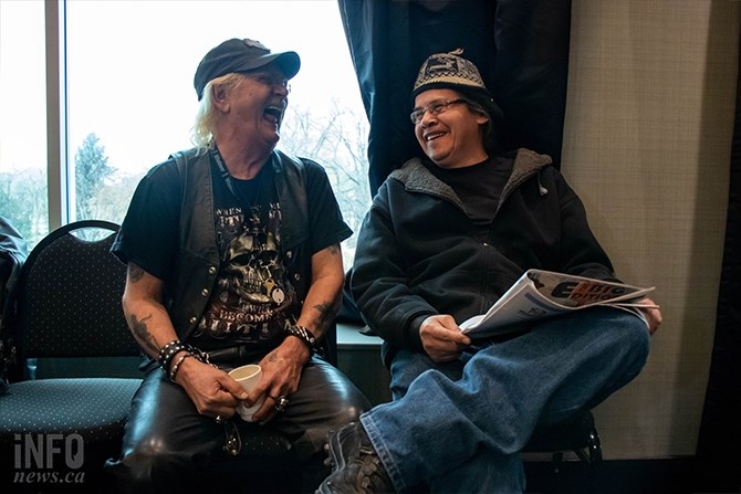 Mike Kelm (left) from the Lived Experience Committee shares a laugh with Randy Sam with the Kamloops Aboriginal Friendship Society holding a copy of The BIG Edition.