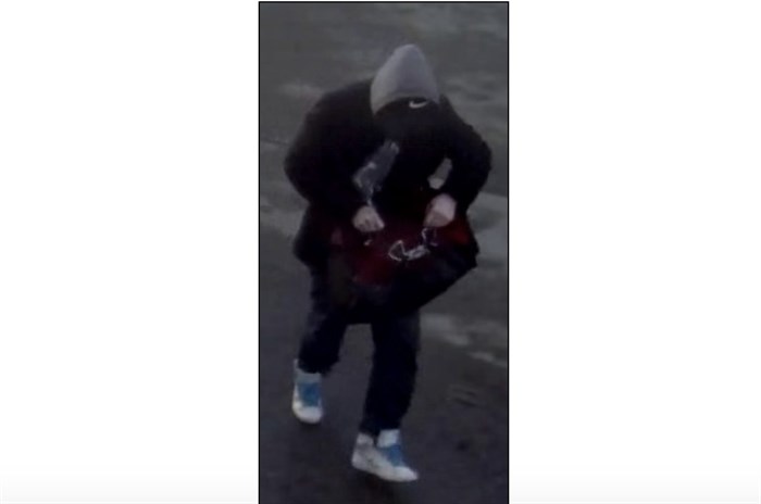 The accomplice is described as roughly the same build and height as the first suspect, and was wearing a black baseball cap, black pea coat with a grey hoody underneath, blue jeans, and white running shoes with light blue shoe laces. He was also carrying a medium-size red and black “Under Armour” duffle bag.
