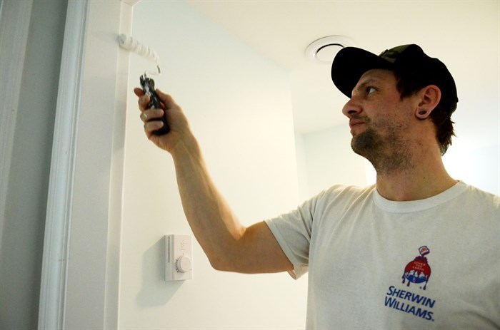 LDR Construction employee Steve Foley adds some paint work during a basement conversion.