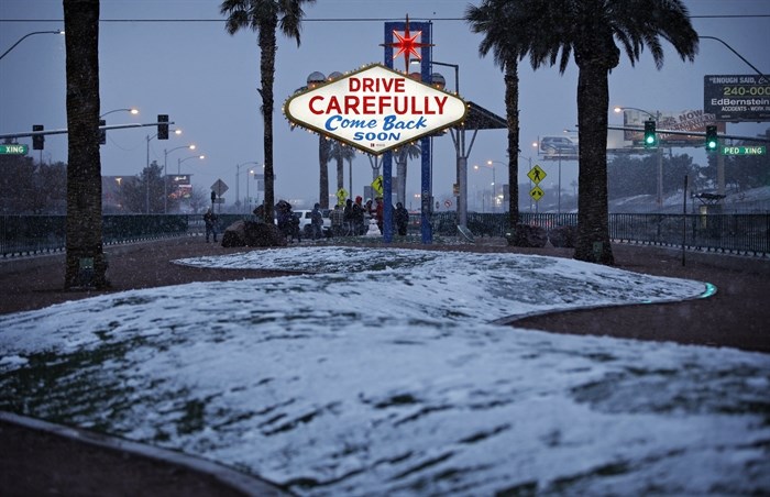 Snow accumulates on a median along the Las Vegas Strip at the 