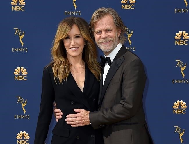 FILE - In this Sept. 17, 2018 file photo, Felicity Huffman, left, and William H. Macy arrive at the 70th Primetime Emmy Awards in Los Angeles. Huffman and Lori Loughlin were charged along with nearly 50 other people Tuesday, March 12, 2019, in a scheme in which wealthy parents bribed college coaches and insiders at testing centers to help get their children into some of the most elite schools in the country, federal prosecutors said.