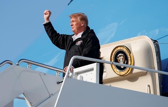 President Donald Trump gestures to people cheering on the tarmac as he arrives on Air Force One at Palm Beach International Airport, in West Palm Beach, Fla., Friday, March 8, 2019, en route to Mar-a-lago in Palm Beach, Fla.