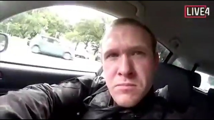 This image taken from the alleged shooter’s video, which was filmed Friday, March 15, 2019, shows him as he drives and he looks over to three guns on the passenger side of his vehicle in New Zealand. A witness says many people have been killed in a mass shooting at a mosque in the New Zealand city of Christchurch. Police have not described the scale of the shooting but urged people to stay indoors.