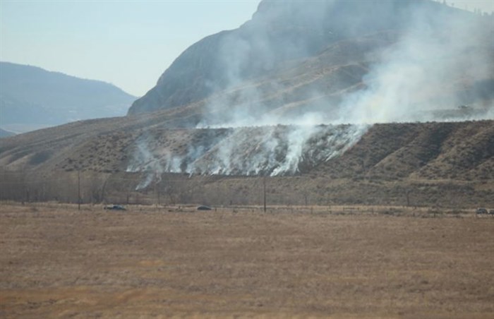 Smoke can be seen coming from a grass fire west of the city on Monday, March 18, 2019.