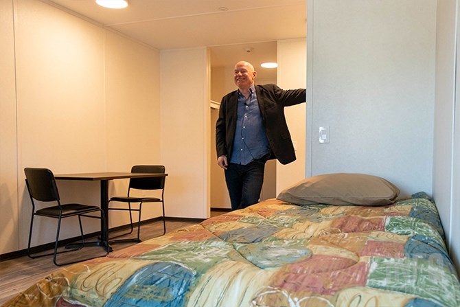 Bob Hughes, executive director of Spero House, stands in one of the 320-square-foot units.