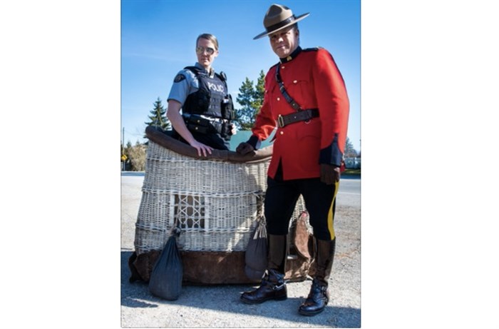 Maple Ridge RCMP officers stand in the hot air balloon basket that's a part of their April Fools' Day announcement. A media release says they will be piloting a hot air balloon program to aide in aerial surveillance. 
