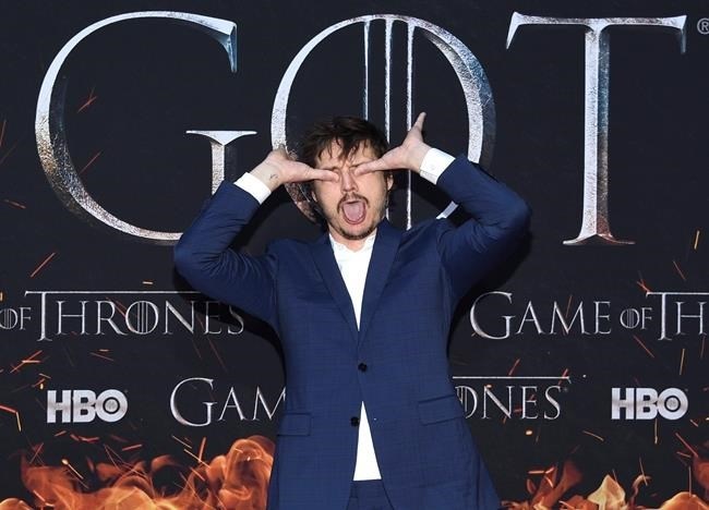 Pedro Pascal gestures as he walks the red carpet at HBO's 
