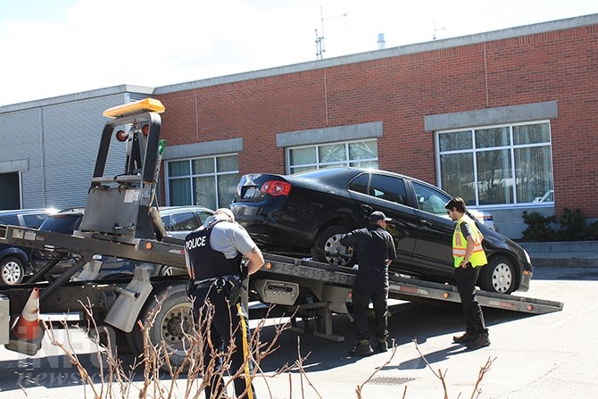 Penticton RCMP examine a black Jetta believed to be the the suspect's vehicle in today's shooting rampage in Penticton, April 16, 2019.