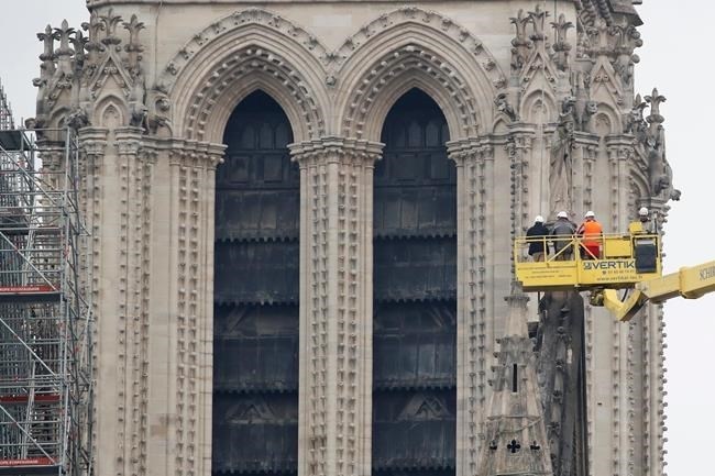 A crane lifts experts as they inspect the damaged Notre Dame cathedral after the fire in Paris, Tuesday, April 16, 2019. Experts are assessing the blackened shell of Paris' iconic Notre Dame cathedral to establish next steps to save what remains after a devastating fire destroyed much of the almost 900-year-old building. With the fire that broke out Monday evening and quickly consumed the cathedral now under control, attention is turning to ensuring the structural integrity of the remaining building.