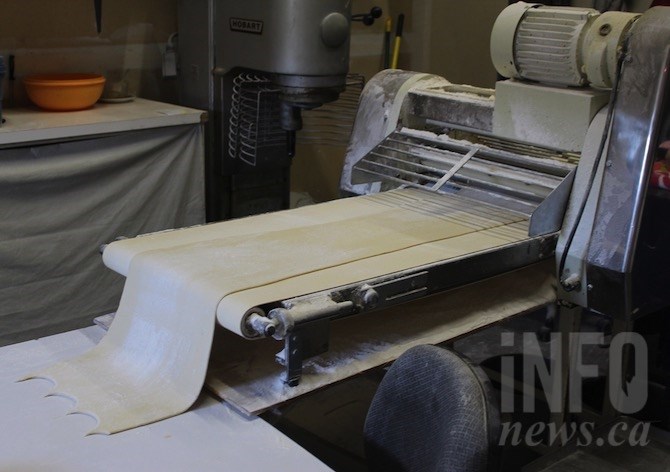 Perogies start as mashed potatoes that are made into a dough and run through this rolling machine.