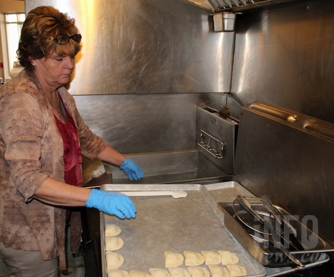 Owner Darlene Warwaruk places a tray of perogies into boiling water to cook.