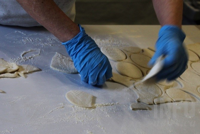 Then the dough is cut into hundreds of rounds.