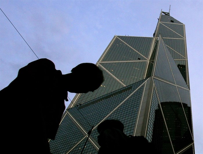 FILE - In this Friday, May 19, 2006, file photo, pedestrians walk past the Bank of China building in Hong Kong, designed by American architect I.M. Pei.