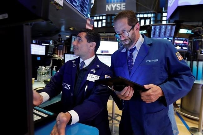 FILE - In this May 28, 2019, file photo specialist Peter Mazza, left, and trader Stephen Gilmartin work on the floor of the New York Stock Exchange. The U.S. stock market opens at 9:30 a.m. EDT on Friday, May 31.