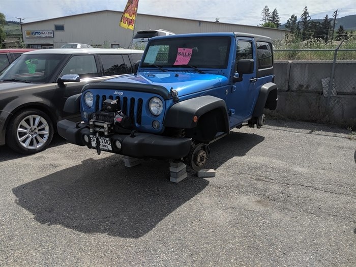 Swan Lake Motors owner Joe Skerritt discovered the Jeep's wheels were missing when he arrived at work, Monday, June 3, 2019.