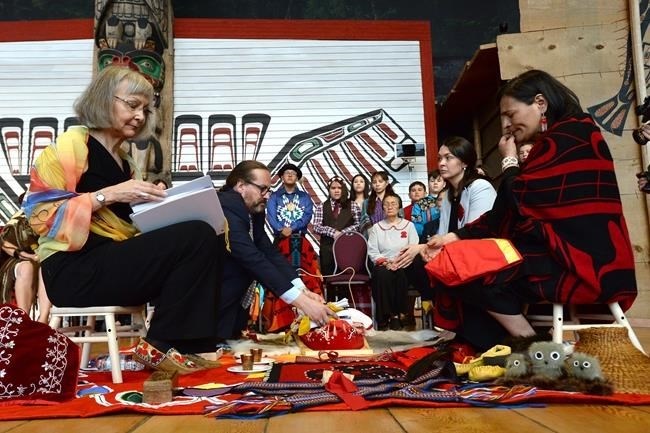 Chief commissioner Marion Buller, left to right, and commissioners Brian Eyolfson, Qajaq Robinson and Michele Audette prepare the final report to give to the government at the closing ceremony for the National Inquiry into Missing and Murdered Indigenous Women and Girls in Gatineau, Que., on Monday, June 3, 2019. 