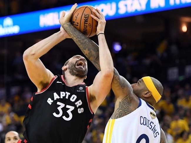Toronto Raptors centre Marc Gasol (33) and Golden State Warriors centre DeMarcus Cousins (0) battle for the ball during second half basketball action in Game 3 of the NBA Finals in Oakland, California on Wednesday, June 5, 2019. 