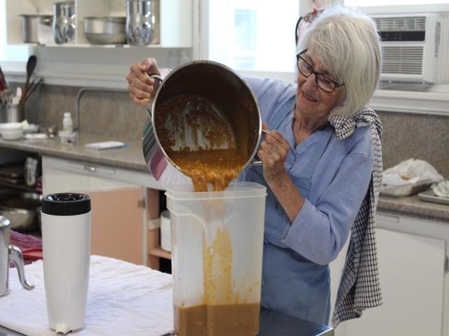 Ann Eggleton, a volunter at the Mount Paul Commnity Food Centre, saves some leftover peanut vegetable soup.