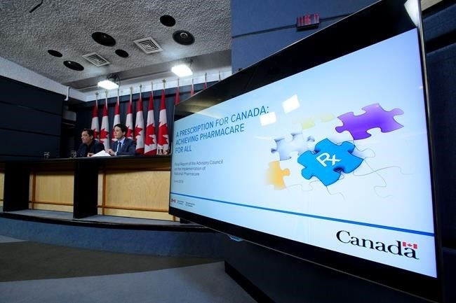 Dr. Eric Hoskins, Chair of the Advisory Council on the Implementation of National Pharmacare, is accompanied by Vincent Dumez, Member of the Advisory Council on the Implementation of National Pharmacare, during a press conference at the National Press Theatre in Ottawa on Wednesday, June 12, 2019. 