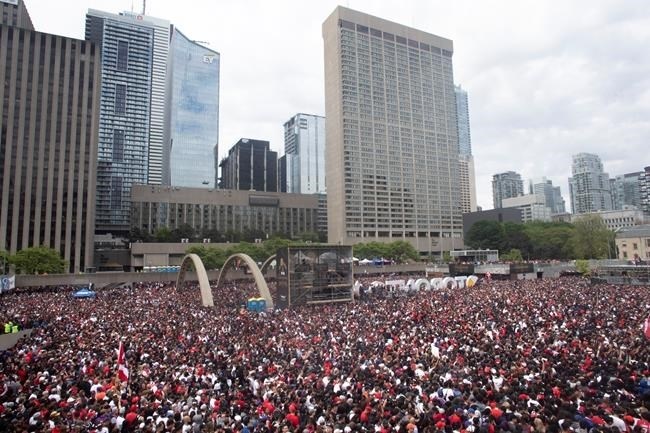 Crowds gather in Nathan Phillips Square as they prepare to celebrate the Toronto Raptors winning the NBA Championship in Toronto on Monday, June 17, 2019.