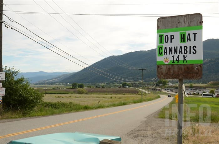 A sign on Westside Road counts down the kilometres to an unlicensed cannabis store, in this June 2019 photo.