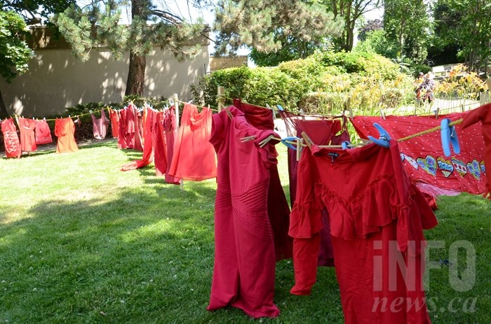 Red dresses hang in Justice Park.