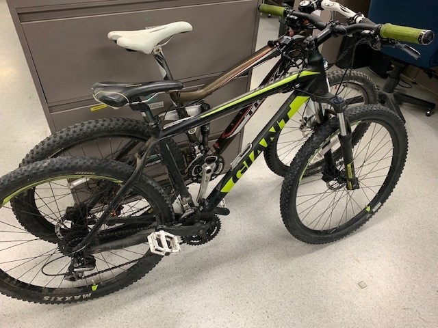 Side view of a black and green GIANT bike.
