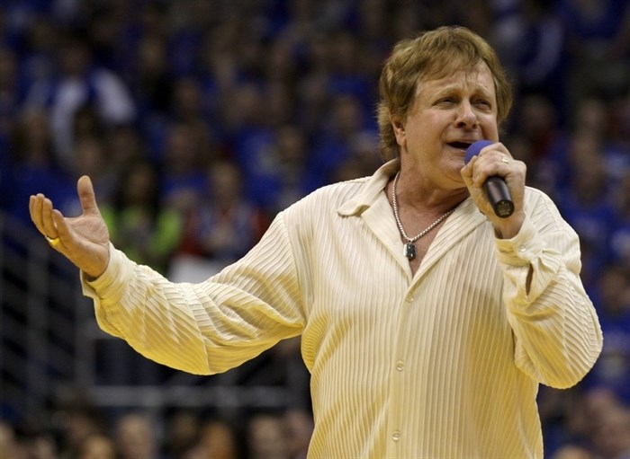FILE - In this Jan. 25, 2010 file photo, Eddie Money sings the national anthem before an NCAA college basketball game between Kansas and Missouri in Lawrence, Kan. Family members have said Eddie Money has died on Friday, Sept. 13, 2019. 