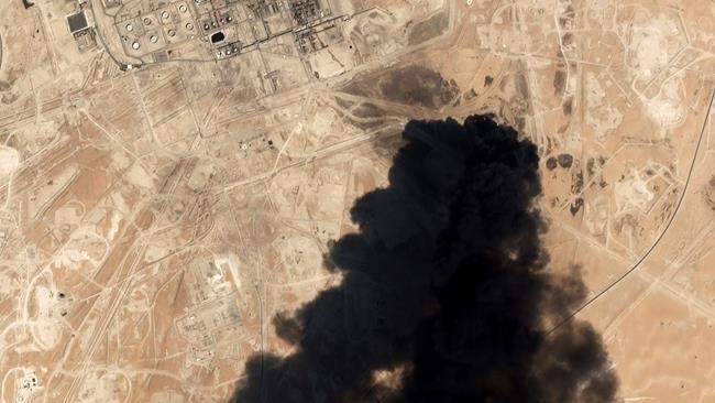 FILE - In this Saturday, Sept. 14, 2019 file photo, a satellite image from Planet Labs Inc. shows thick black smoke rising from Saudi Aramco's Abqaiq oil processing facility in Buqyaq, Saudi Arabia. The assault on the beating heart of Saudi Arabia's vast oil empire follows a new and dangerous pattern that's emerged across the Persian Gulf this summer of precise attacks that leave few obvious clues of who launched them. 