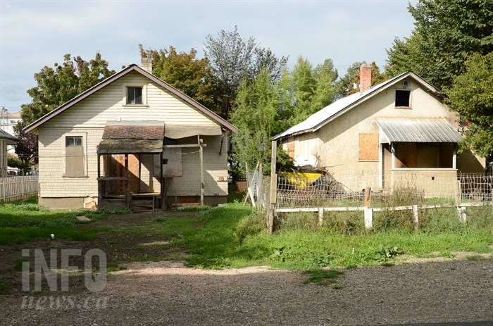 The property on the left was raided by police in August and then deemed unfit for habitation.