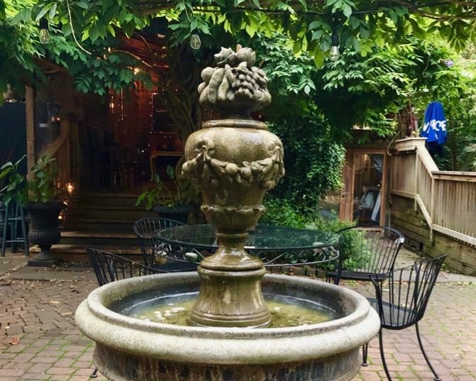 The charming Tuscany Restaurant courtyard is complete with Italian style fountain & twinkle lights - perfect for a fun or romantic evening under the stars