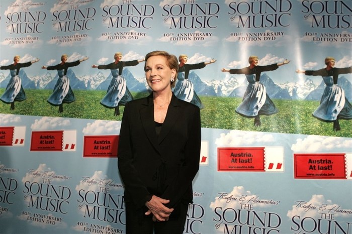 FILE - This Nov. 10, 2005 file photo shows actress Julie Andrews posing in front of posters for the 40th anniversary special edition DVD release party of the 