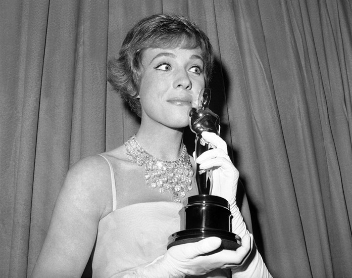 FILE - This April 6, 1965 file photo shows actress Julie Andrews holding her best actress Oscar for 