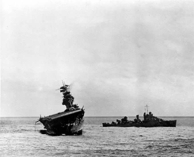 FILE - In this June 4, 1942 file photo provided by the U.S. Navy shows the USS Yorktown listing heavily to port after being struck by Japanese bombers and torpedo planes in the Battle of Midway.