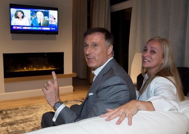 People's Party of Canada Leader Maxime Bernier and his wife Catherine Letarte watches elections results on television Monday, October 21, 2019, in Beauceville, Que. Canadians are going to the polls in a general election.