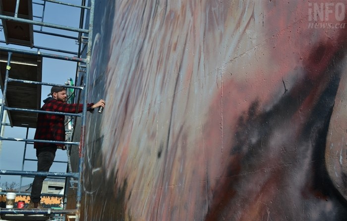 Abney puts some final details on his newest mural.