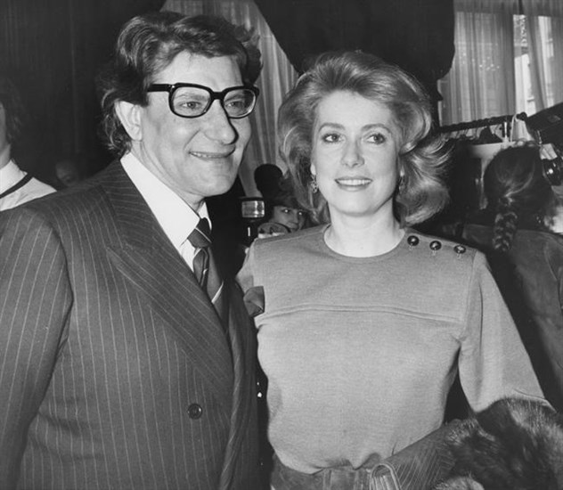 FILE - In this Jan. 30 1985 file photo, French actress Catherine Deneuve congratulates French fashion designer Yves Saint Laurent after the presentation of spring-summer haute couture collection in Paris. Denueve's family said in a statement released Wednesday, Nov. 6, 2019, that the 76-year-old actress suffered a 