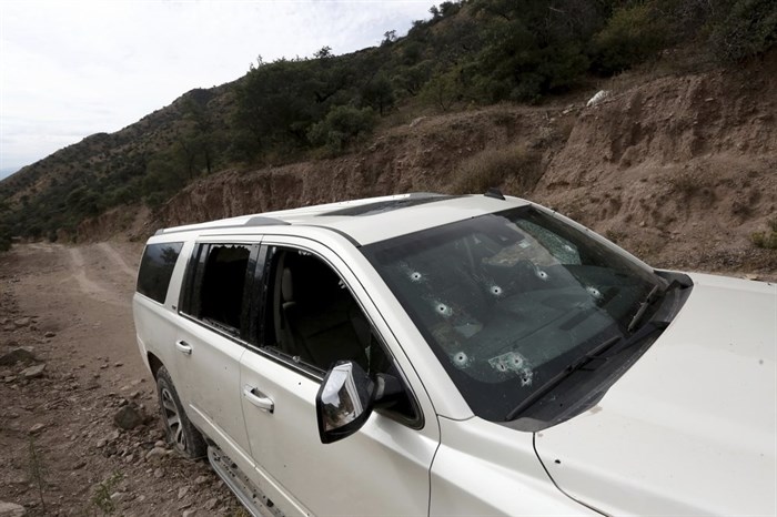 A bullet-riddled vehicle that members of LeBaron family were traveling in sits parked on a dirt road near Bavispe, at the Sonora-Chihuahua border, Mexico, Wednesday, Nov 6, 2019. 