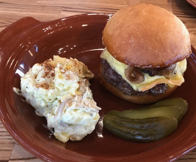 Row Fourteen features loads of veggie dishes but also meats like this amazing dry age cheeseburger with Farmhouse cheese, beet ketchup and warm potato salad.